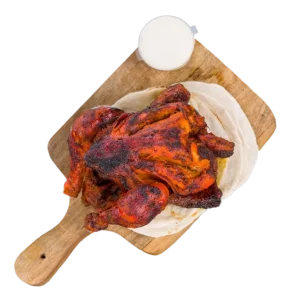 Whole Tandoori Chicken marinated in yogurt and traditional spices, cooked in a tandoor