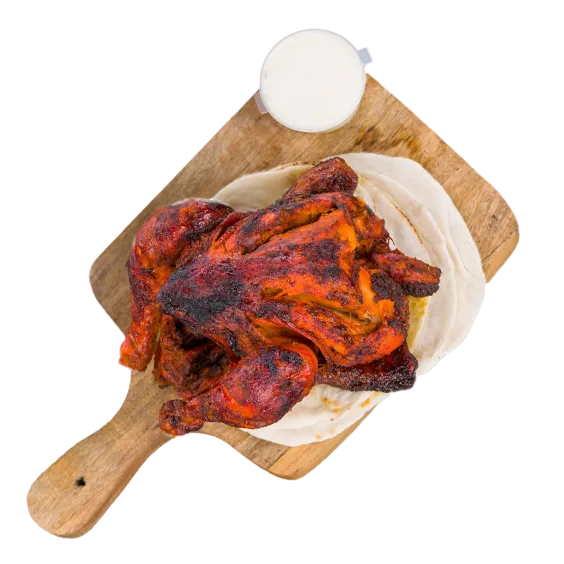 Whole Tandoori Chicken marinated in yogurt and traditional spices, cooked in a tandoor