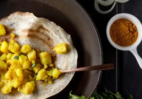 Crispy South Indian masala dosa with turmeric-spiced potato filling served on a plate