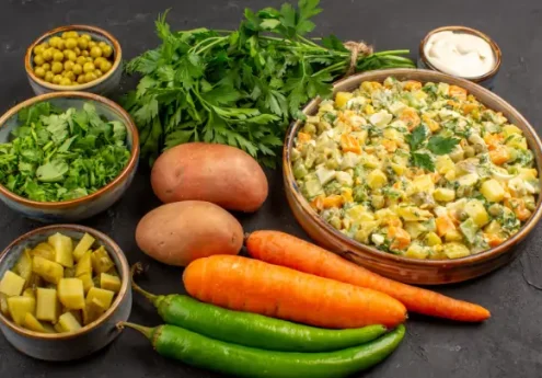 Fresh homemade vegetarian entree prepared with potatoes, carrots, green peas, herbs, and green chilies, served as a healthy mixed vegetable dish.