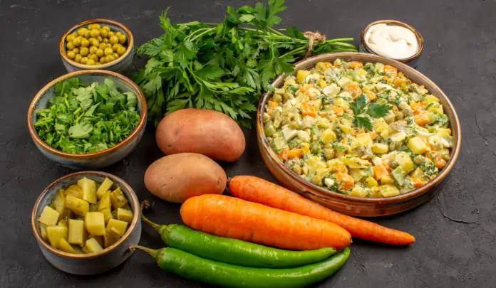 Fresh homemade vegetarian entree prepared with potatoes, carrots, green peas, herbs, and green chilies, served as a healthy mixed vegetable dish.