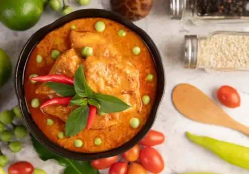 Traditional Kerala spicy fish curry with coconut gravy and red chilies in a bowl